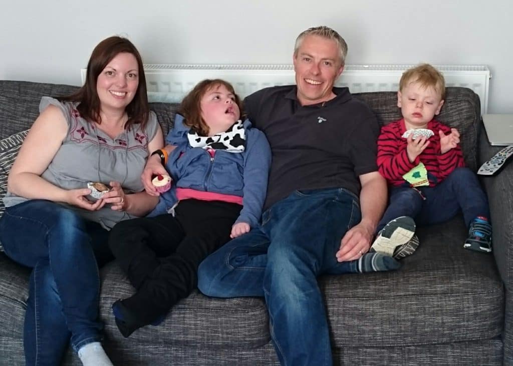 Family sitting together on the sofa.
