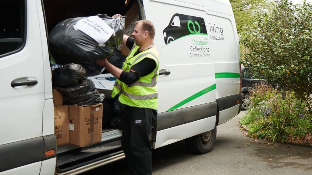 driver packing charity donations from Reigate into a van.