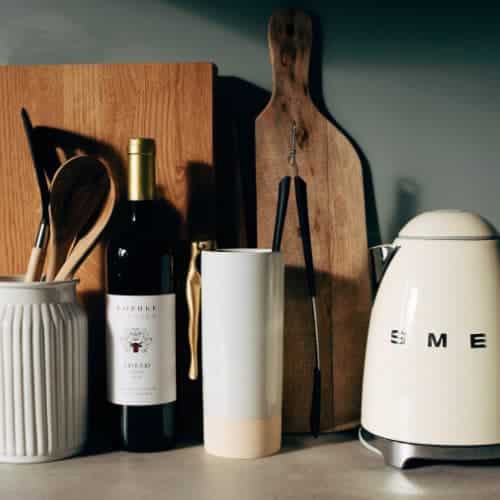 Kettle, crockery on kitchen worksurface.